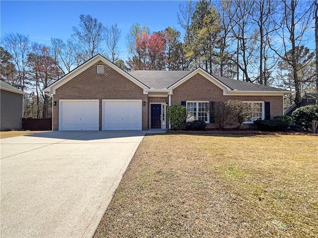 single story home with an attached garage, concrete driveway, brick siding, and a front yard