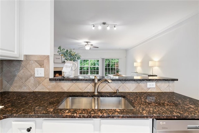 651 Coligny Ct, Atlanta, GA 30350 - kitchen featuring dishwashing machine, white cabinetry, backsplash, a ceiling fan, and dark stone counters