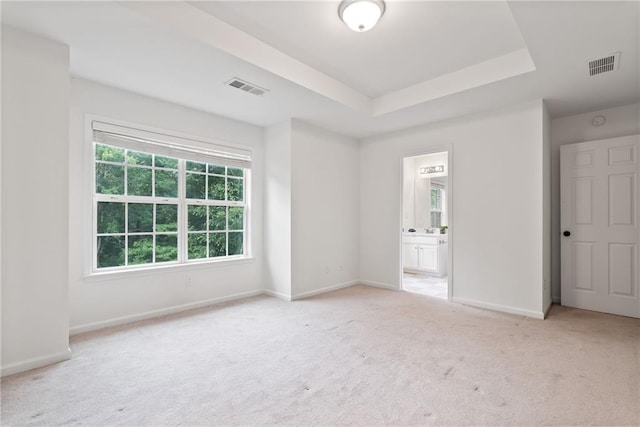651 Coligny Ct, Atlanta, GA 30350 - unfurnished bedroom with light carpet, a tray ceiling, and connected bathroom