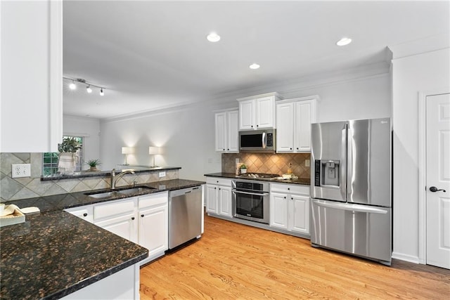 651 Coligny Ct, Atlanta, GA 30350 - kitchen featuring stainless steel appliances, ornamental molding, white cabinets, decorative backsplash, and recessed lighting