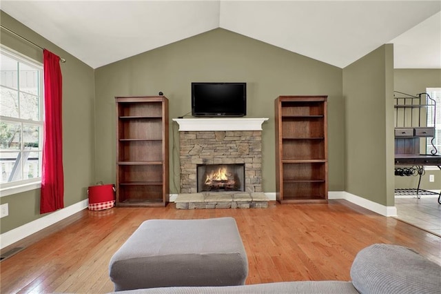 192 Aubrey Ave NE, Calhoun, GA 30701 - living area featuring a stone fireplace, baseboards, lofted ceiling, and wood finished floors