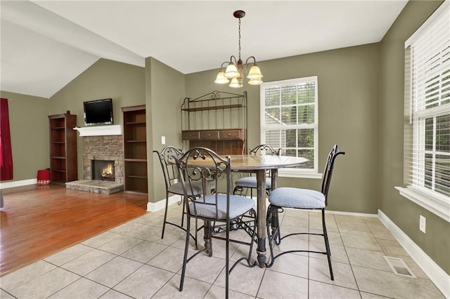 192 Aubrey Ave NE, Calhoun, GA 30701 - dining area featuring visible vents, a chandelier, baseboards, vaulted ceiling, and light tile patterned floors