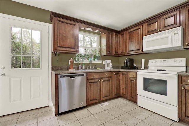 192 Aubrey Ave NE, Calhoun, GA 30701 - kitchen featuring light tile patterned floors, a sink, visible vents, and white appliances