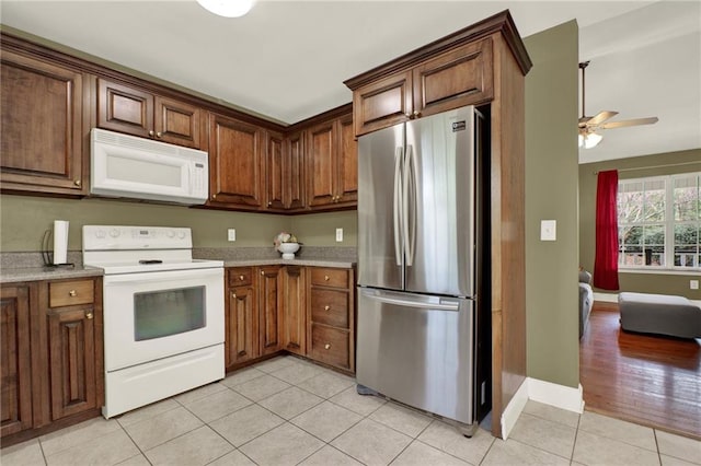192 Aubrey Ave NE, Calhoun, GA 30701 - kitchen featuring light countertops, white appliances, light tile patterned floors, baseboards, and a ceiling fan