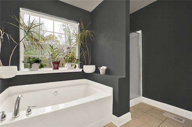 192 Aubrey Ave NE, Calhoun, GA 30701 - bathroom with tile patterned floors, a shower stall, a bath, baseboards, and visible vents