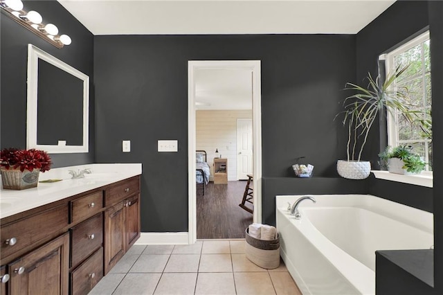 192 Aubrey Ave NE, Calhoun, GA 30701 - ensuite bathroom featuring ensuite bathroom, double vanity, a sink, a garden tub, and tile patterned flooring