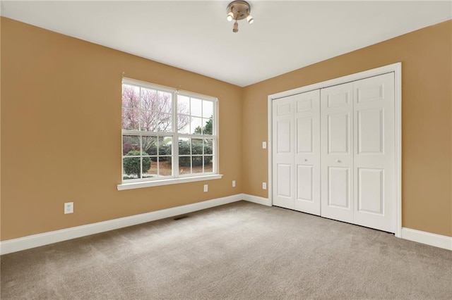 192 Aubrey Ave NE, Calhoun, GA 30701 - unfurnished bedroom featuring carpet floors, a closet, baseboards, and visible vents