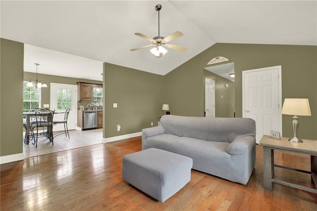 192 Aubrey Ave NE, Calhoun, GA 30701 - living area with baseboards, lofted ceiling, light wood-style flooring, and ceiling fan with notable chandelier