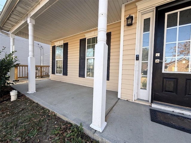 view of exterior entry with a porch