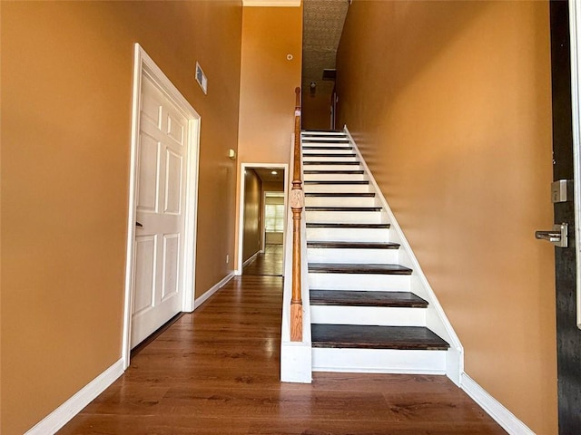 staircase featuring wood-type flooring