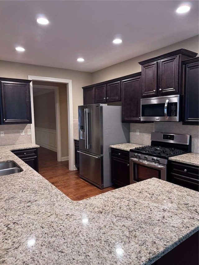 3622 Foxtrot Trl NW, Kennesaw, GA 30144 - kitchen featuring appliances with stainless steel finishes, wood finished floors, light stone counters, a sink, and recessed lighting