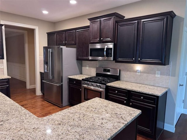3622 Foxtrot Trl NW, Kennesaw, GA 30144 - kitchen featuring stainless steel appliances, dark wood finished floors, backsplash, light stone countertops, and recessed lighting