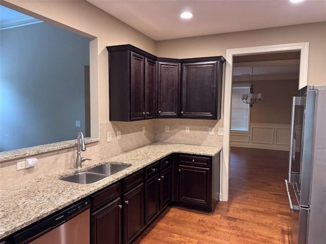 3622 Foxtrot Trl NW, Kennesaw, GA 30144 - kitchen featuring appliances with stainless steel finishes, a sink, light wood finished floors, light stone countertops, and wainscoting