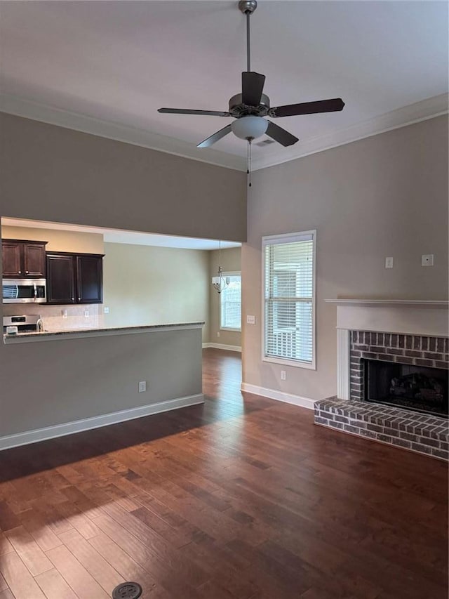 3622 Foxtrot Trl NW, Kennesaw, GA 30144 - unfurnished living room featuring ornamental molding, ceiling fan, dark wood-type flooring, baseboards, and a fireplace