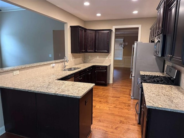 3622 Foxtrot Trl NW, Kennesaw, GA 30144 - kitchen featuring stainless steel appliances, a sink, light wood finished floors, a peninsula, and recessed lighting