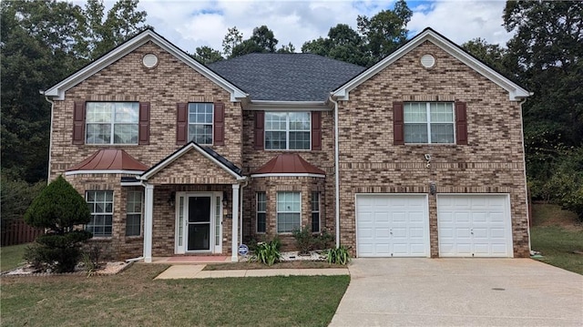 view of front of property featuring a front yard and a garage