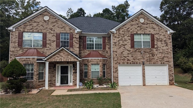 view of front of home featuring a front yard and a garage