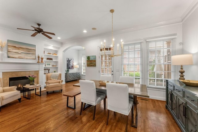 1227 Parkside Village Dr NW, Marietta, GA 30060 - dining space featuring a chandelier, arched walkways, crown molding, a ceiling fan, and dark wood-style flooring