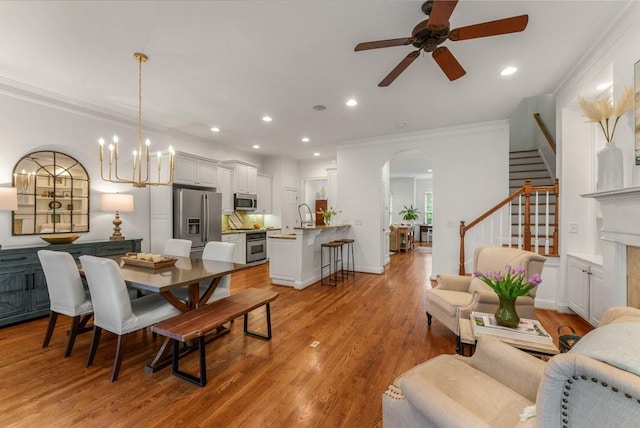 1227 Parkside Village Dr NW, Marietta, GA 30060 - dining space featuring arched walkways, stairs, ornamental molding, ceiling fan, and recessed lighting