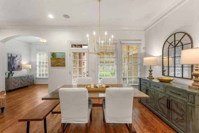 1227 Parkside Village Dr NW, Marietta, GA 30060 - dining room with arched walkways, wood finished floors, a chandelier, and crown molding