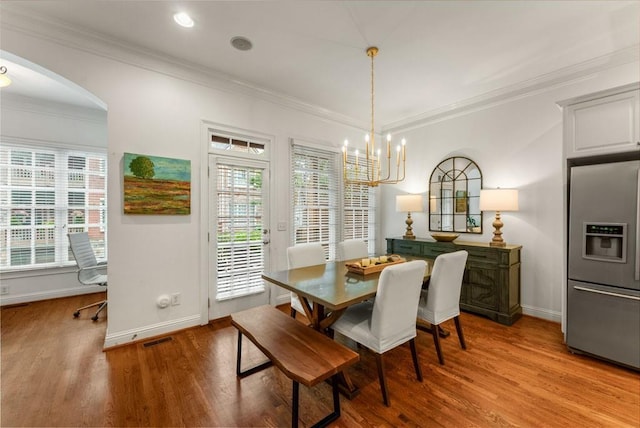 1227 Parkside Village Dr NW, Marietta, GA 30060 - dining area featuring light wood-style floors, a chandelier, baseboards, plenty of natural light, and ornamental molding