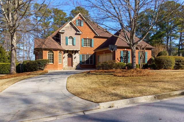 view of front of house featuring a garage and a front lawn