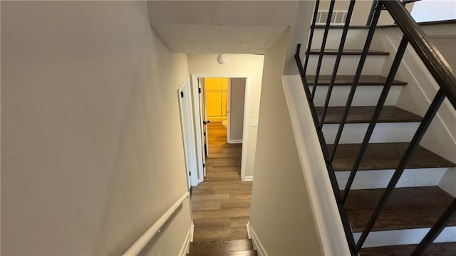 staircase with wood-type flooring