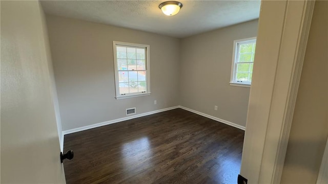 empty room featuring dark hardwood / wood-style floors