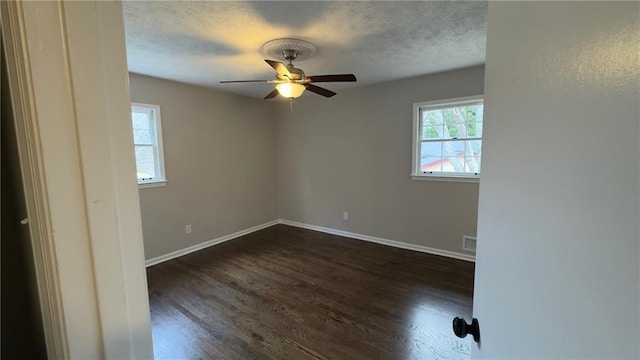 spare room with ceiling fan and dark wood-type flooring