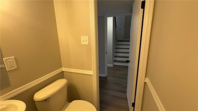 bathroom with wood-type flooring and toilet