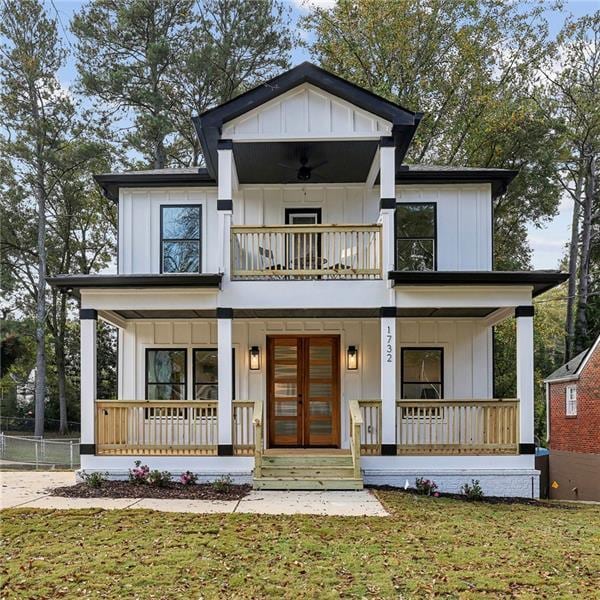 view of front facade featuring a porch, a front yard, ceiling fan, and french doors