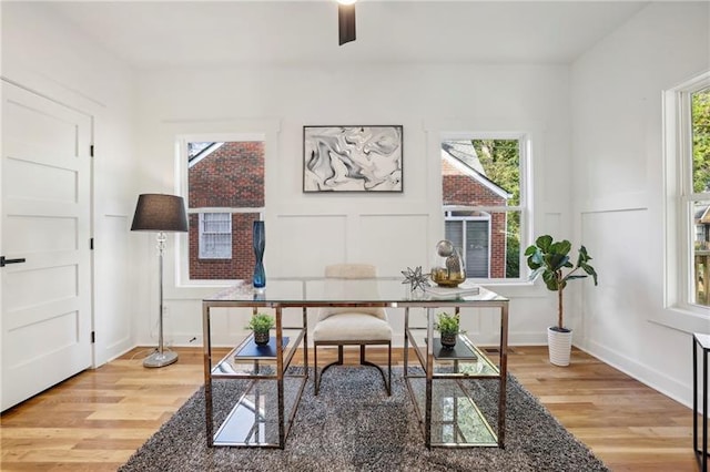 office with wood-type flooring and ceiling fan