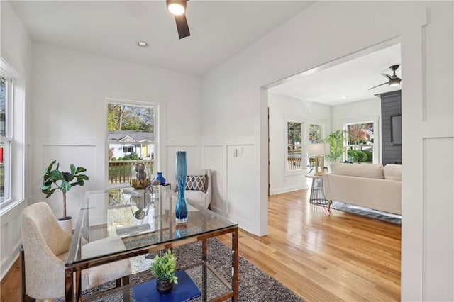 dining area with wood-type flooring, plenty of natural light, and ceiling fan