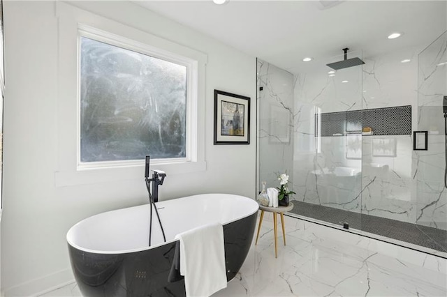 bathroom featuring shower with separate bathtub