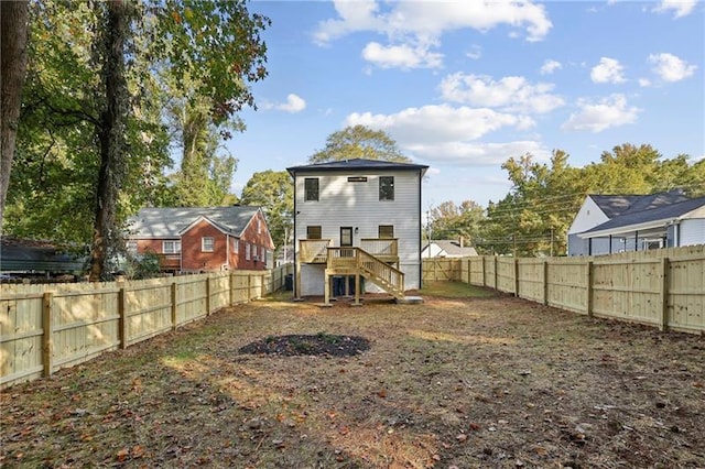 rear view of house with a wooden deck