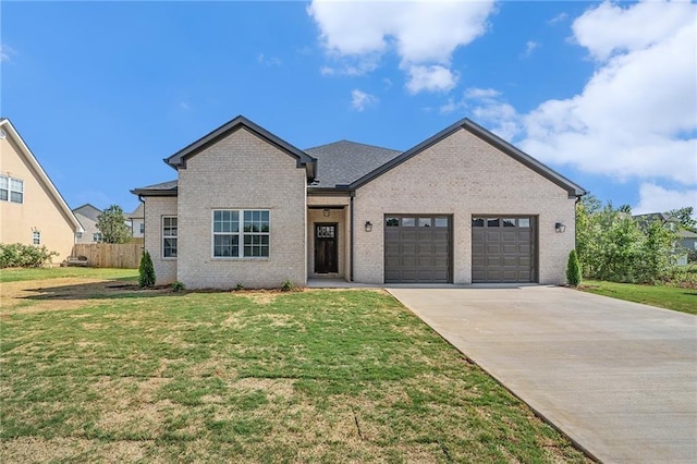 view of front of home with a front yard and a garage