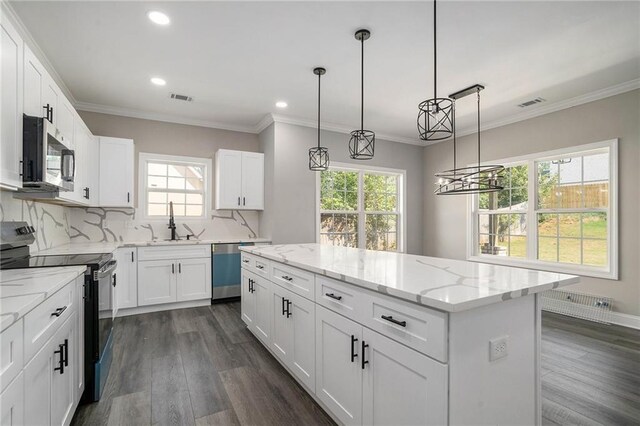 kitchen featuring white cabinetry, a center island, and appliances with stainless steel finishes