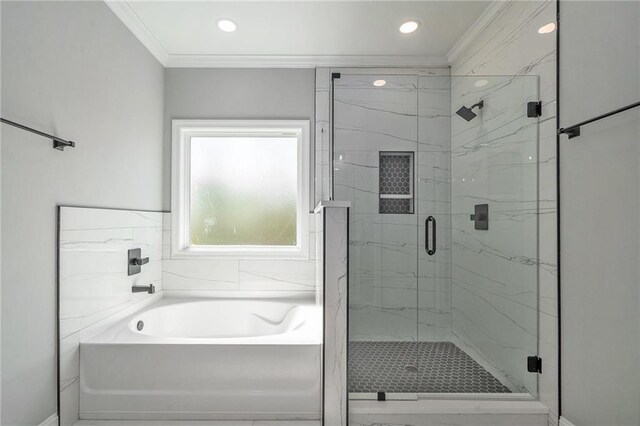 bathroom with separate shower and tub and ornamental molding