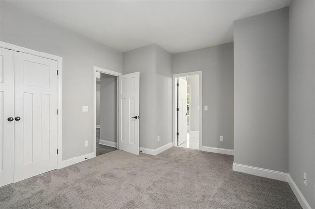 unfurnished bedroom featuring carpet floors and a closet