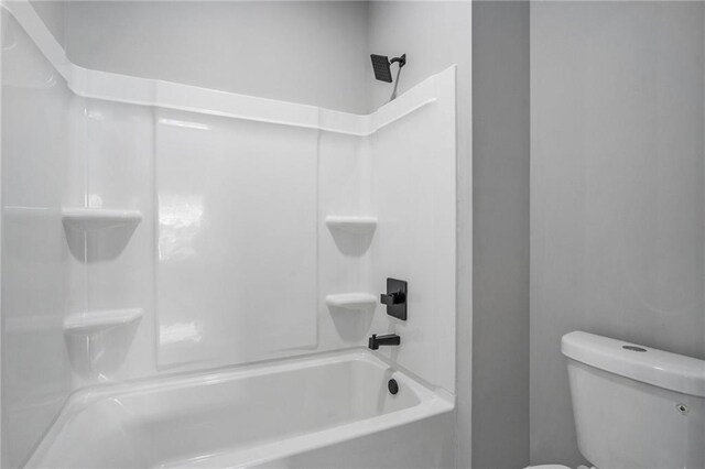 bathroom with shower / bathing tub combination and toilet