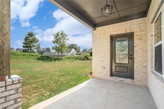 entrance to property featuring a lawn