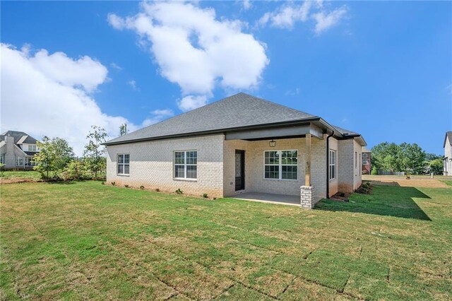 back of house featuring a yard and a patio