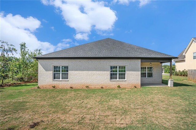 back of house featuring a yard and a patio