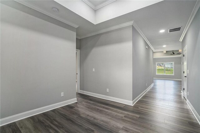 unfurnished room featuring dark hardwood / wood-style flooring, ceiling fan, and crown molding