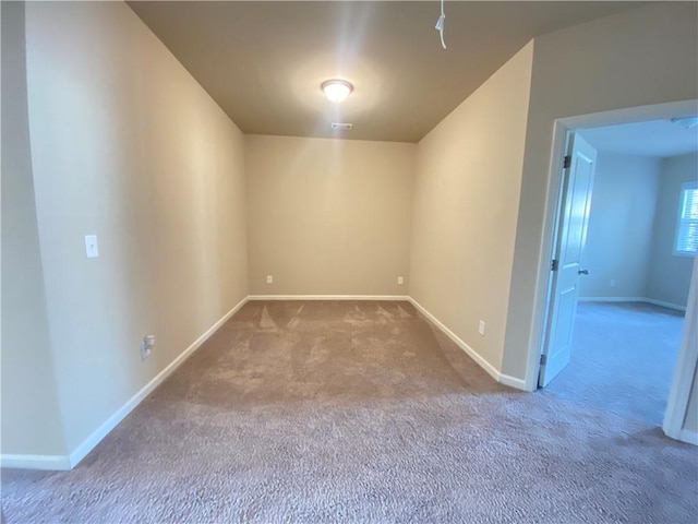 unfurnished room featuring light colored carpet