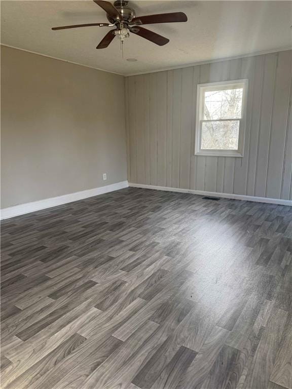 spare room with ceiling fan and wood-type flooring