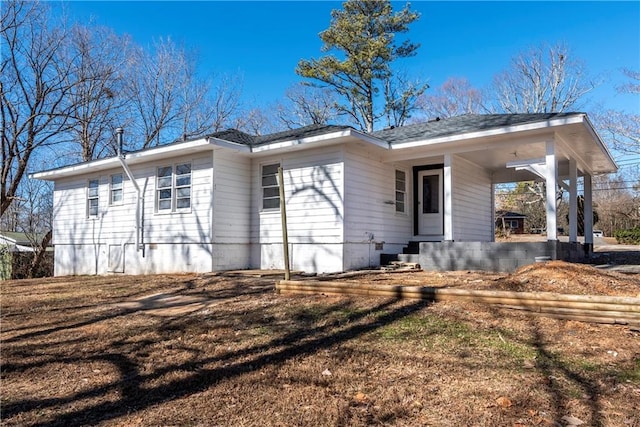 rear view of house featuring covered porch