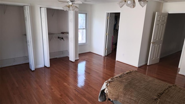 bedroom with ceiling fan, baseboards, and dark wood-type flooring