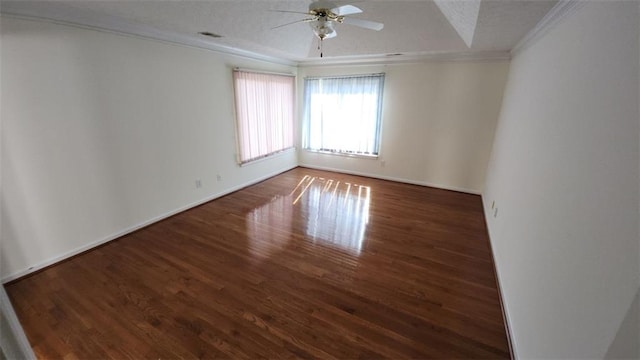 unfurnished room with ceiling fan, ornamental molding, dark wood finished floors, and visible vents