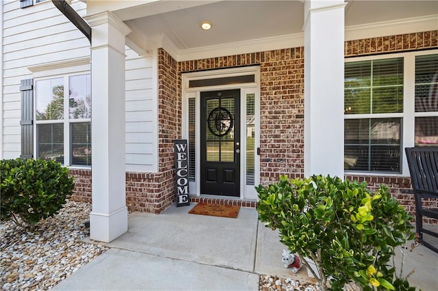 entrance to property featuring covered porch